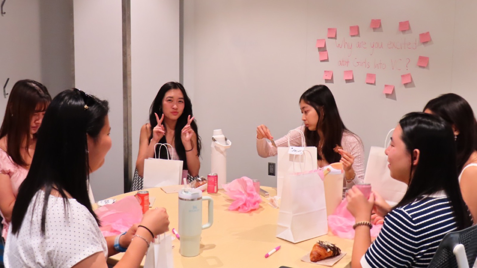 Fellows chatting around a table at a Girls Into VC kickoff